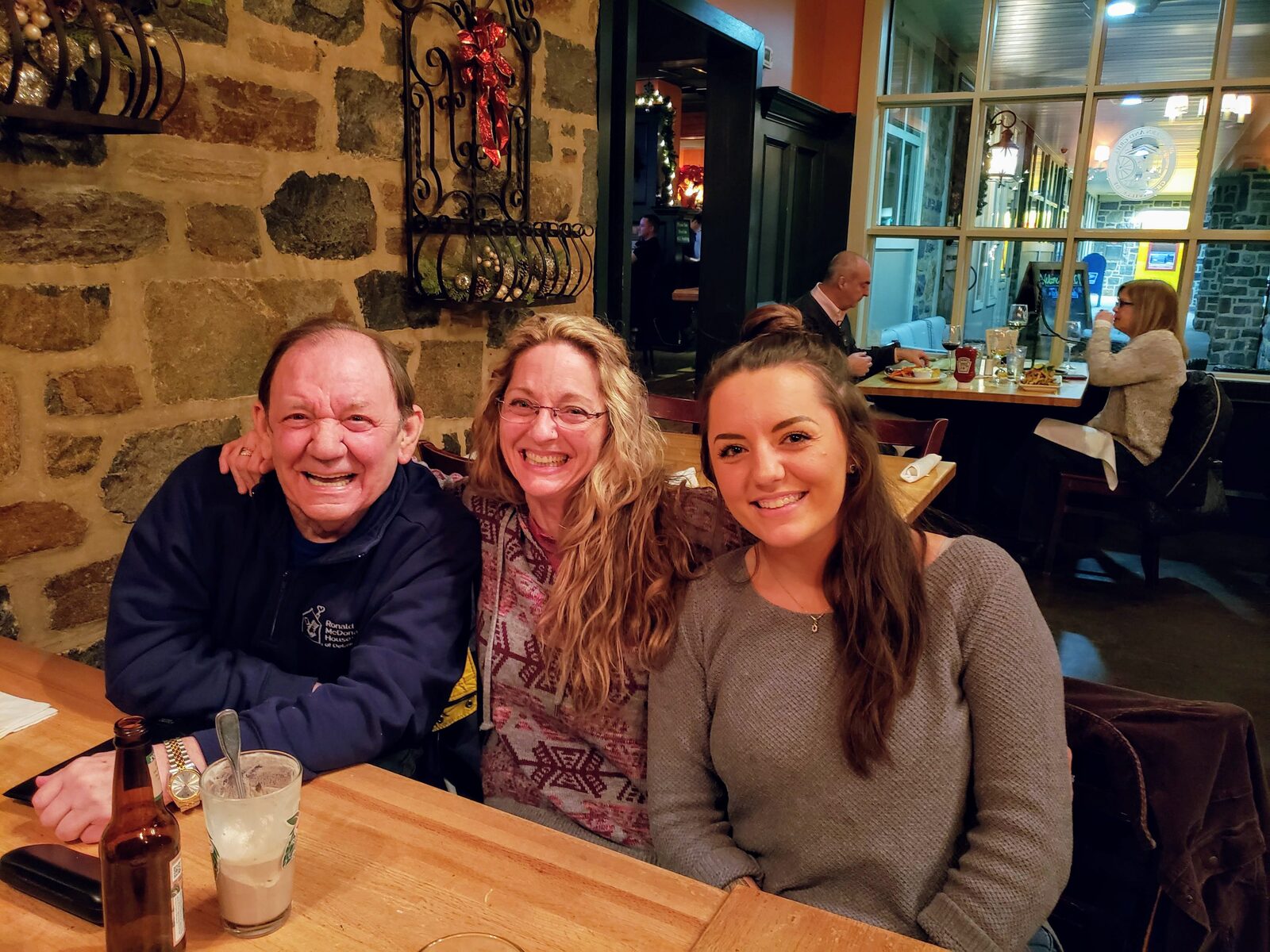 Woman laughing with her father over dinner at a restaurant