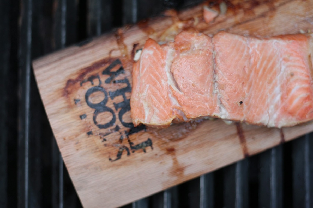 A fillet of deep orange-pink wild salmon on a wooden board