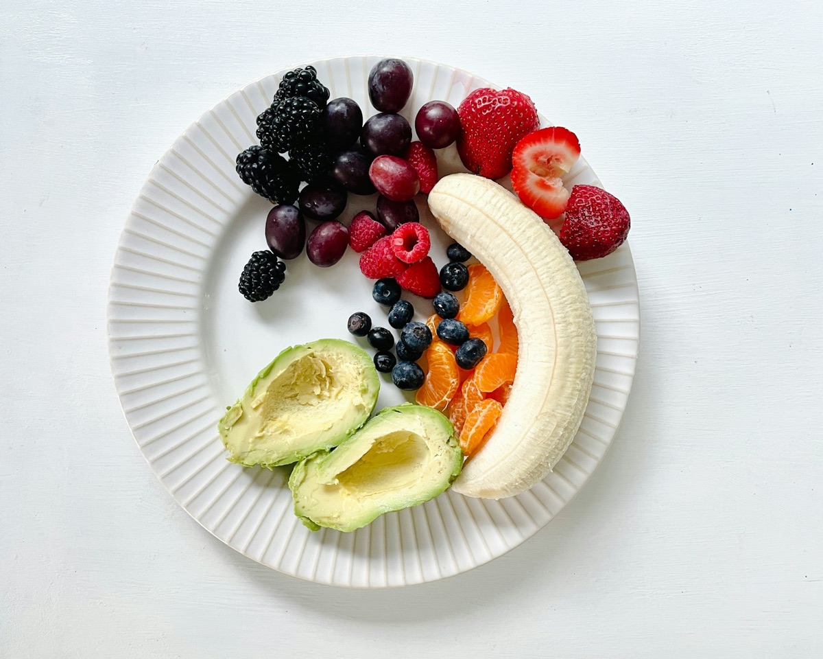 An overhead plate of colorful whole foods — fruits and vegetables
