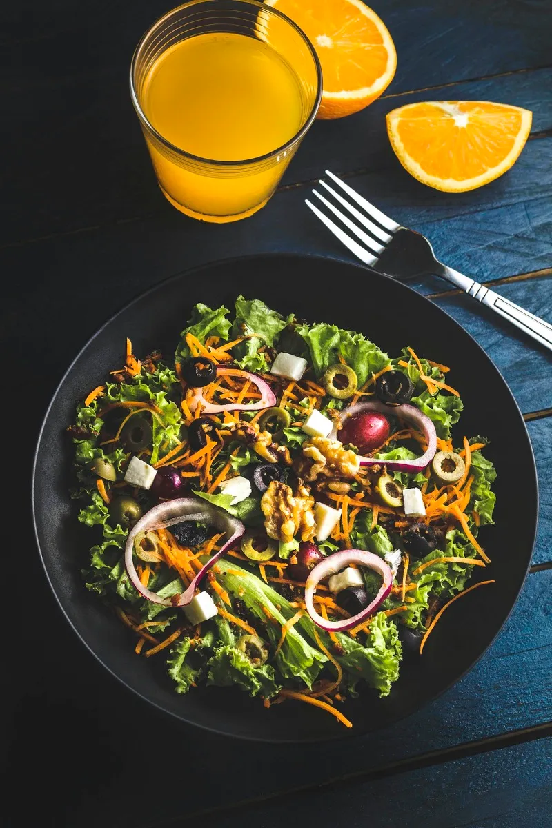 Nutrient-dense salad with greens, carrots, and walnuts