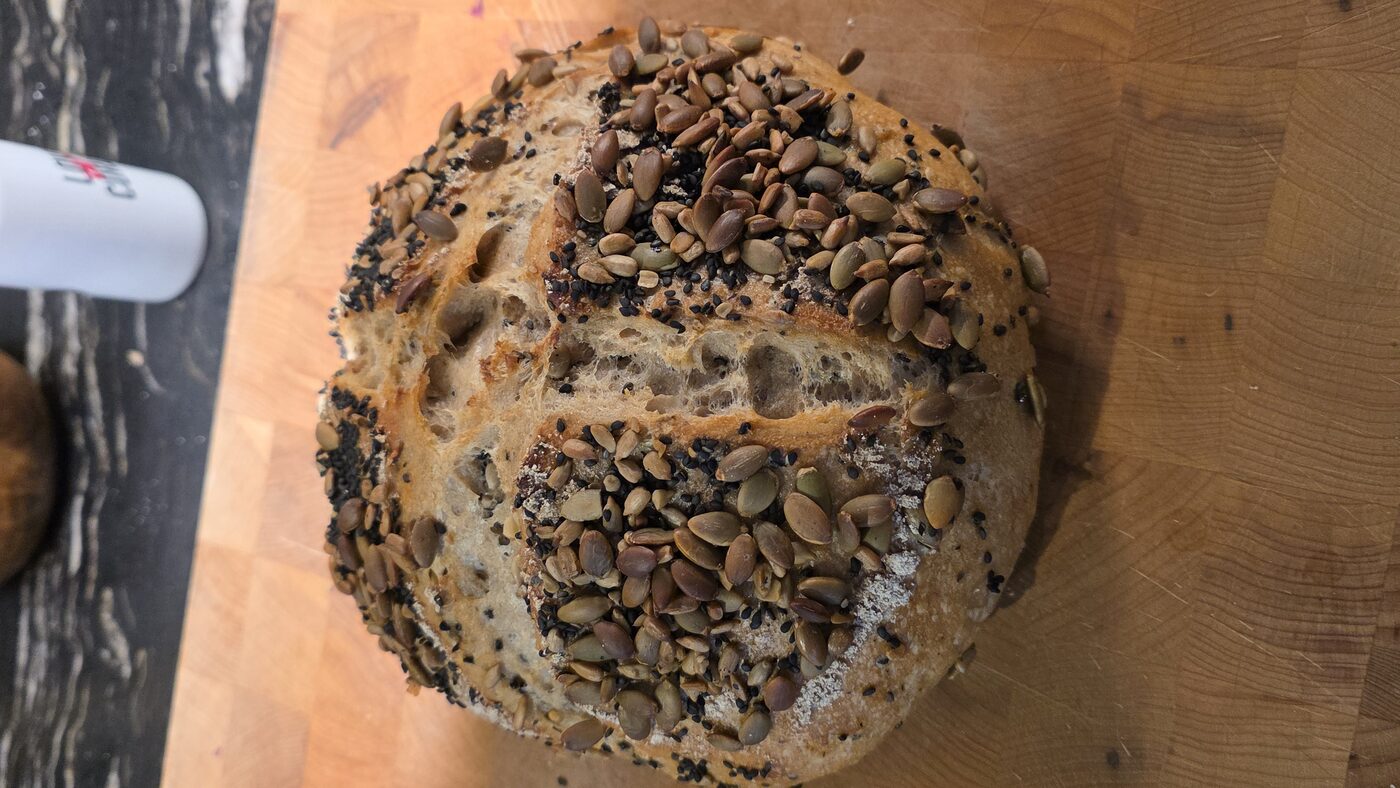 Seeded sourdough loaf on a butcher block